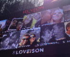 As part of Revlon's social media campaign, photos with the hashtag #LOVEISON have a chance to be seen on Revlon's Times Square digital billboard