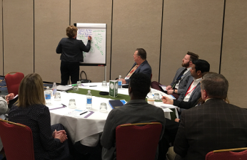 Amber Specialty Pharmacy's Julie Zatizabel guides her roundtable group in a discussion on health outcomes