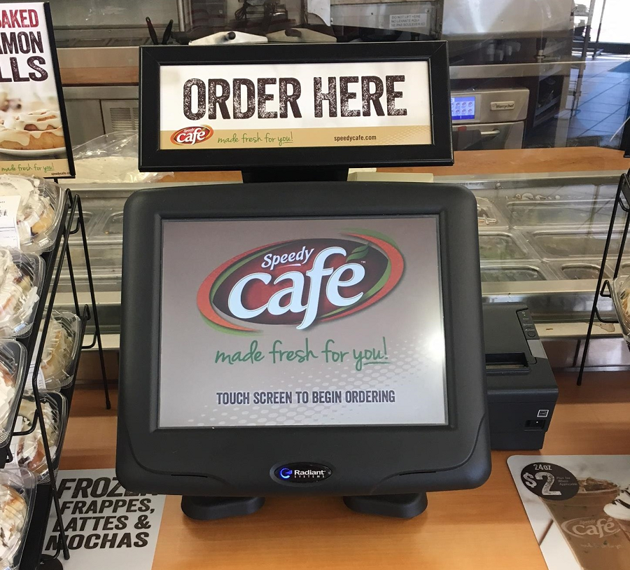 Consumers order meals from the touchscreen kiosks at the counter