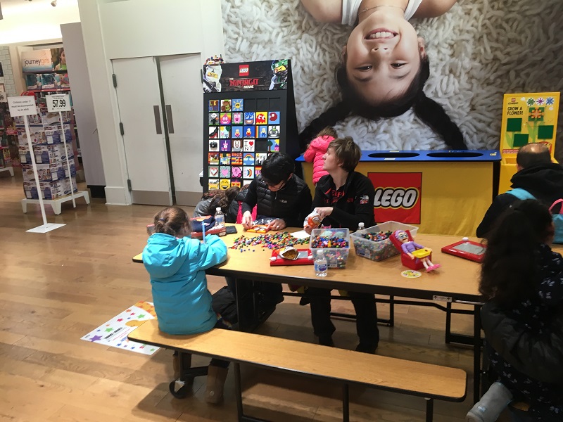 A parent and child checking out toys at the Toys R Us Play Lab
